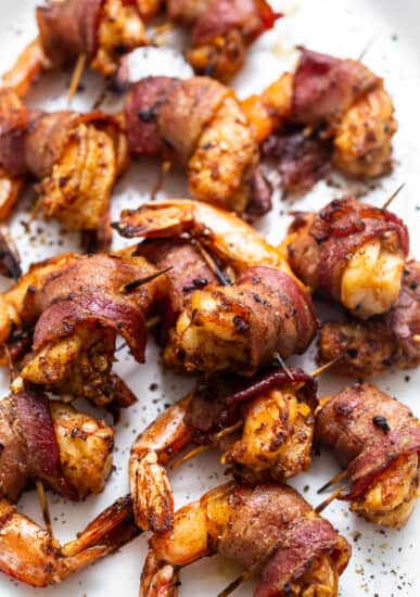 Bacon wrapped shrimp on a plate.