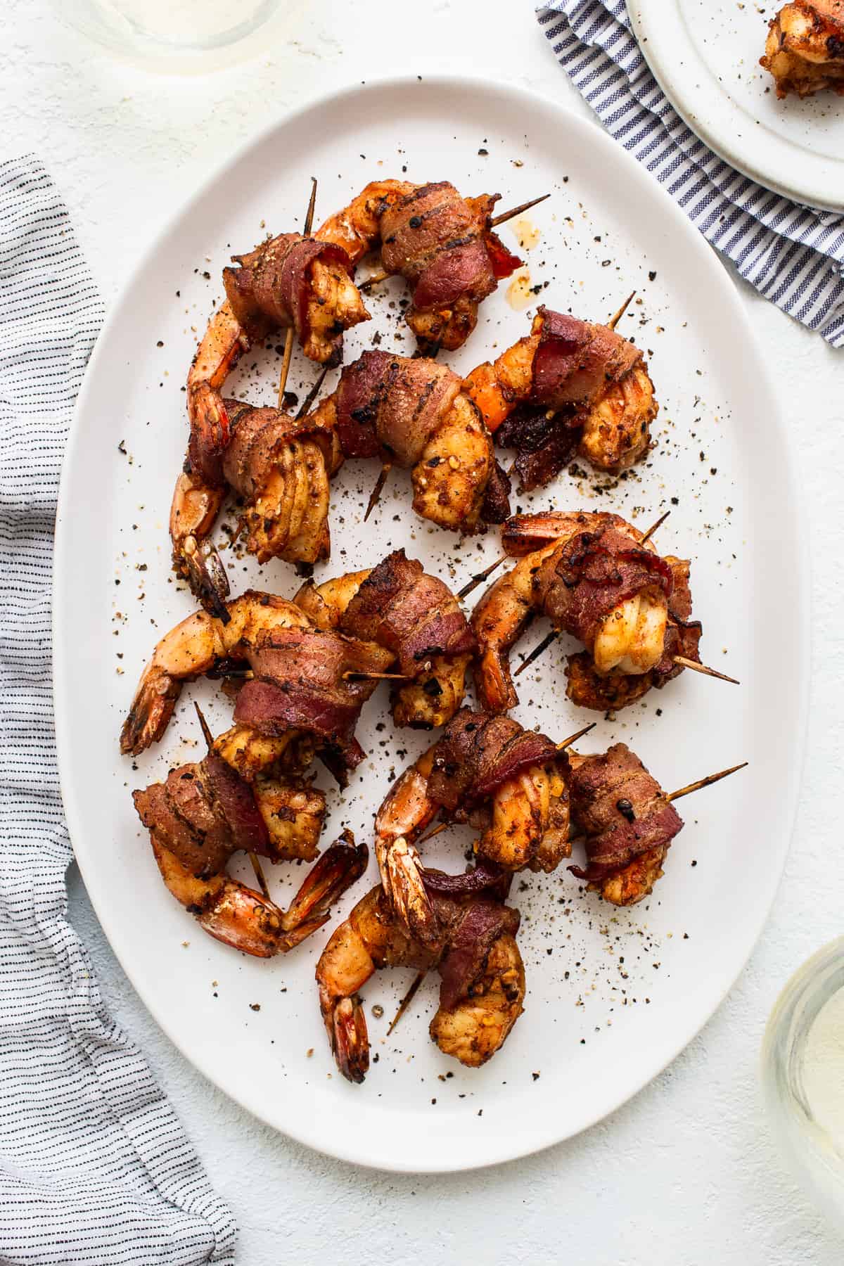 Bacon wrapped shrimp on a platter.