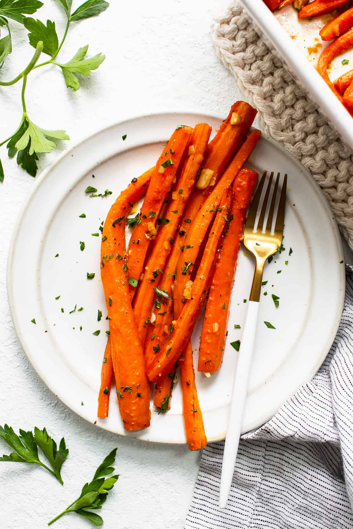 Garlic glazed carrots on a plate with a fork.