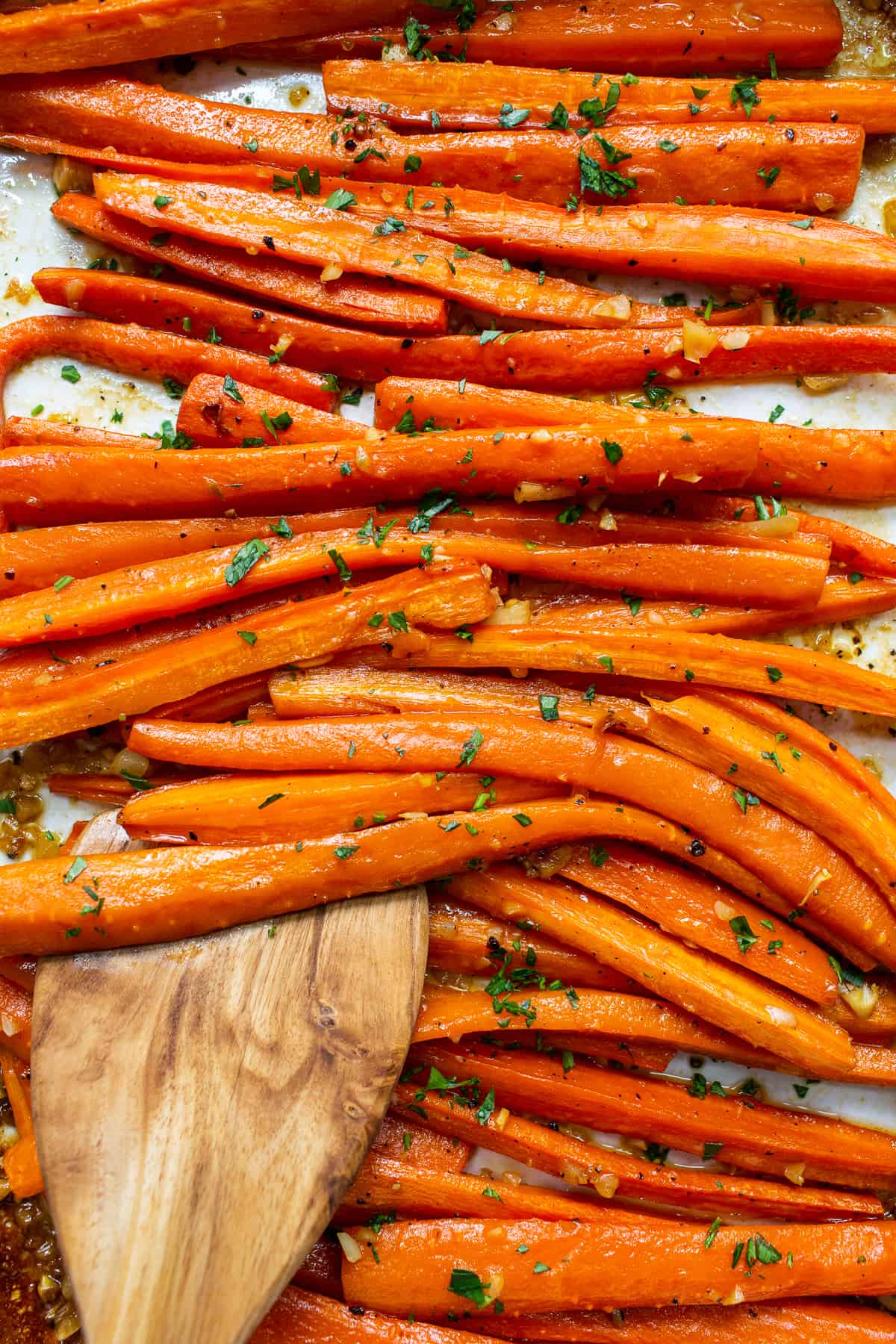 Garlic glazed carrots topped with parsley.