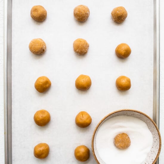 A tray of peanut butter balls on a white surface.