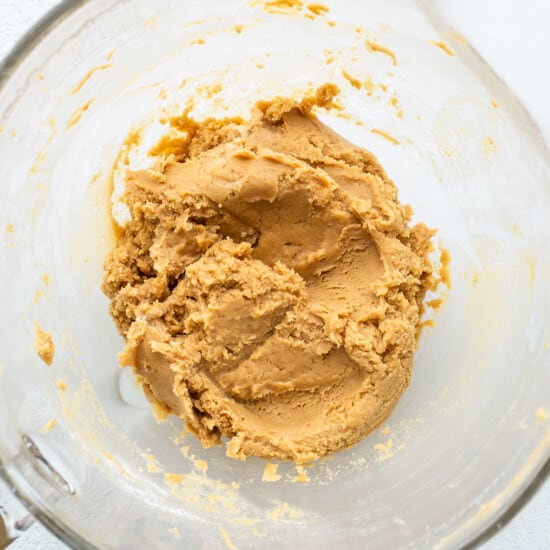 Peanut butter in a glass mixing bowl.