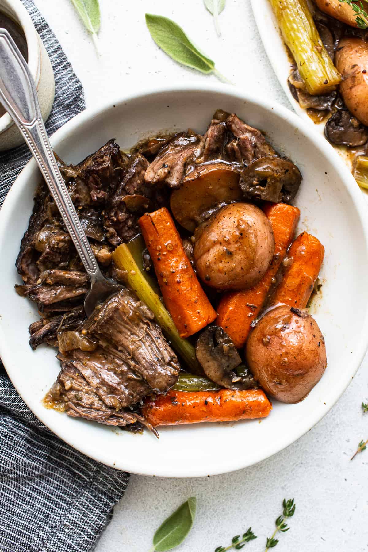 Pot roast in a bowl with a fork.