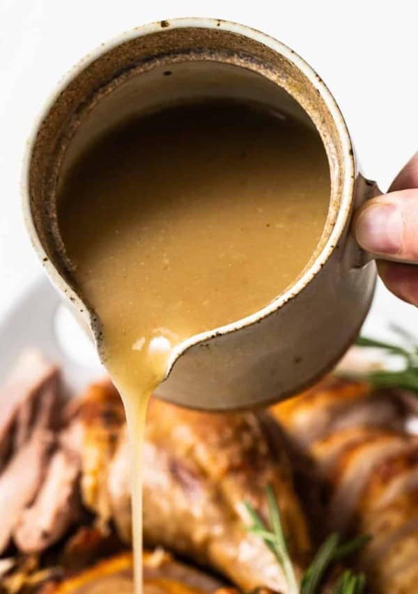 Turkey gravy being poured out of a cup