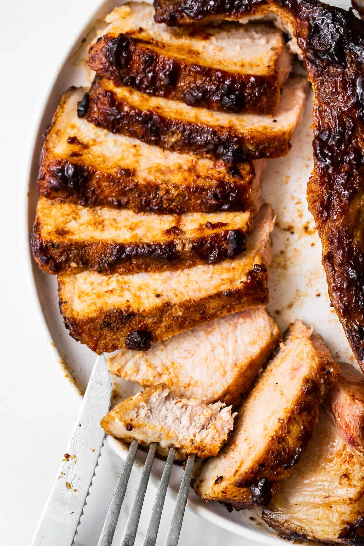 Sliced pork chops on a plate.