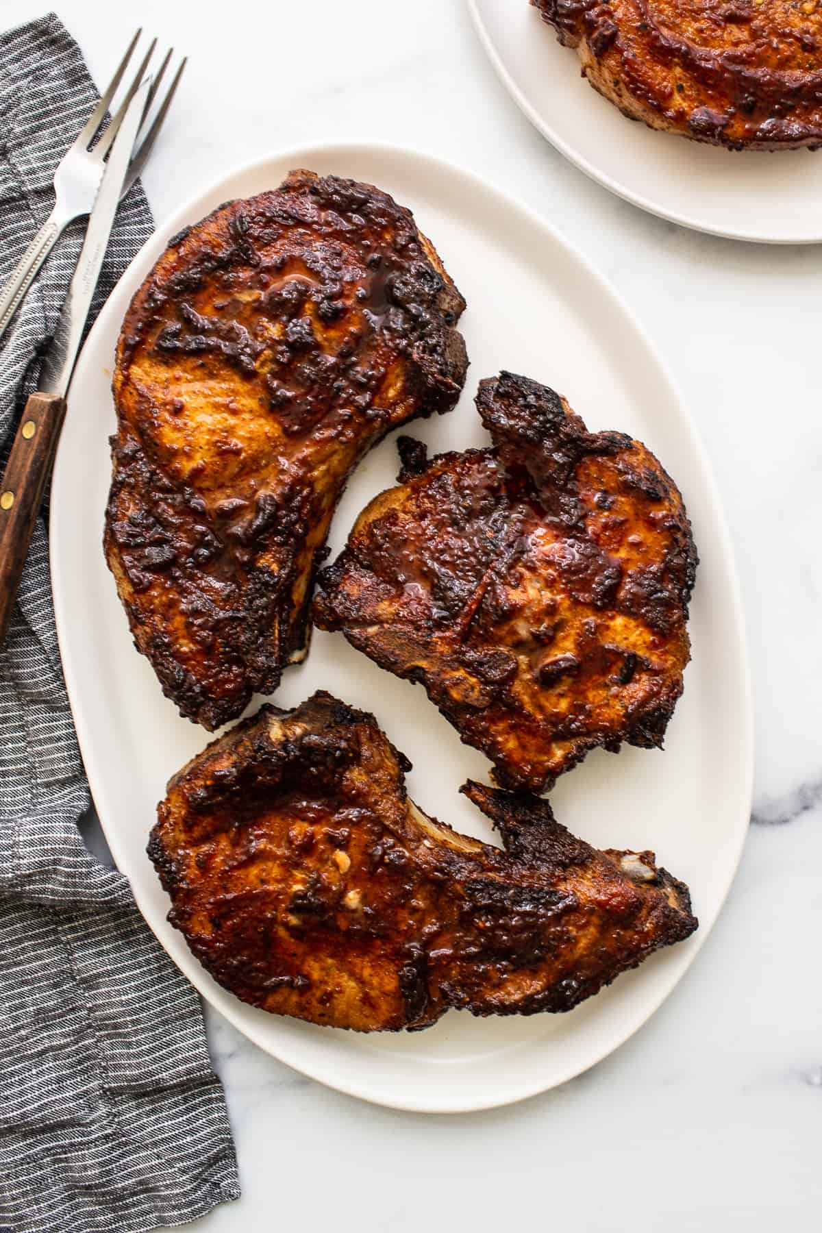 Air fryer pork chops on a plate.