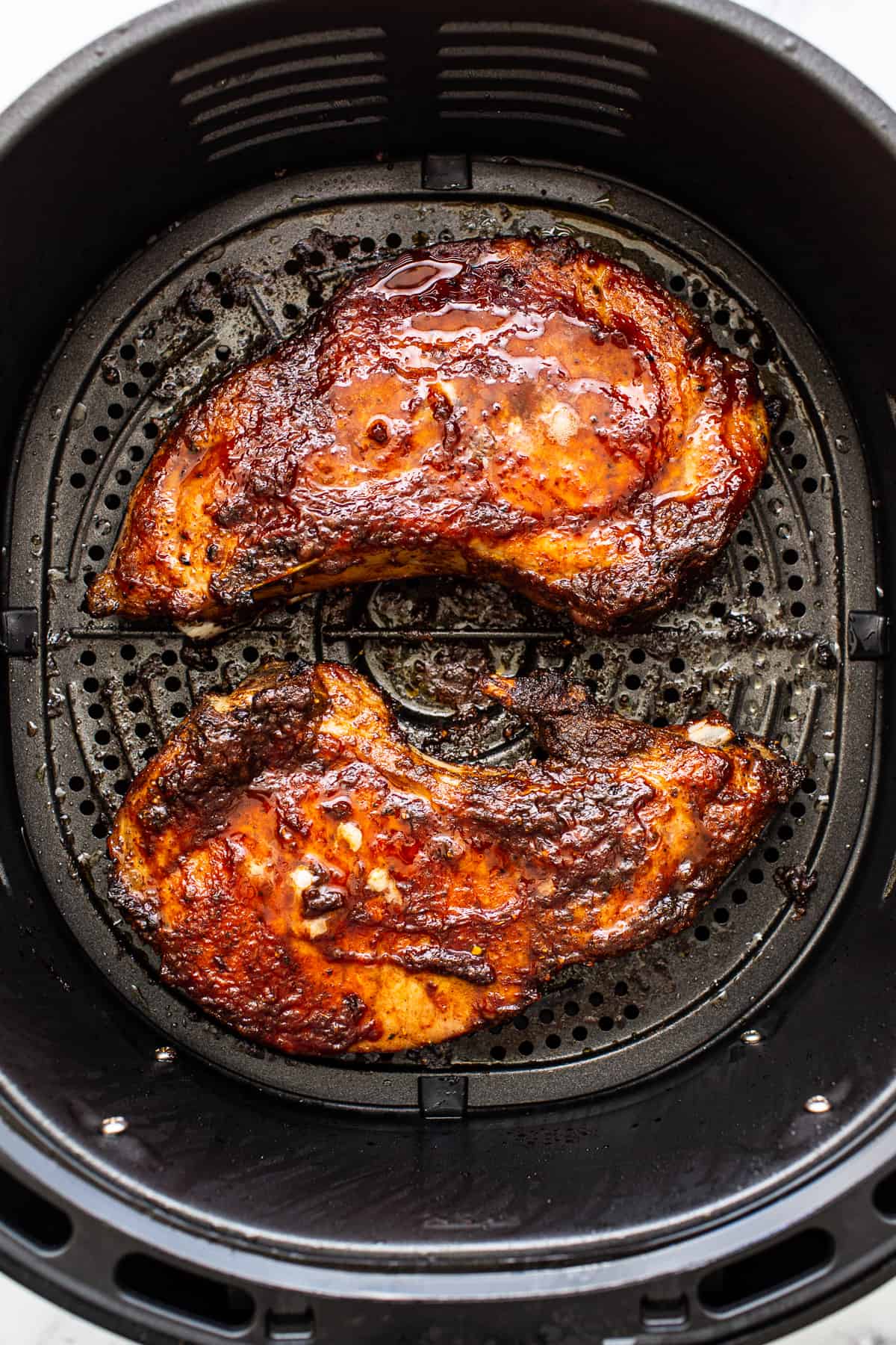 Pork chops in an air fryer.