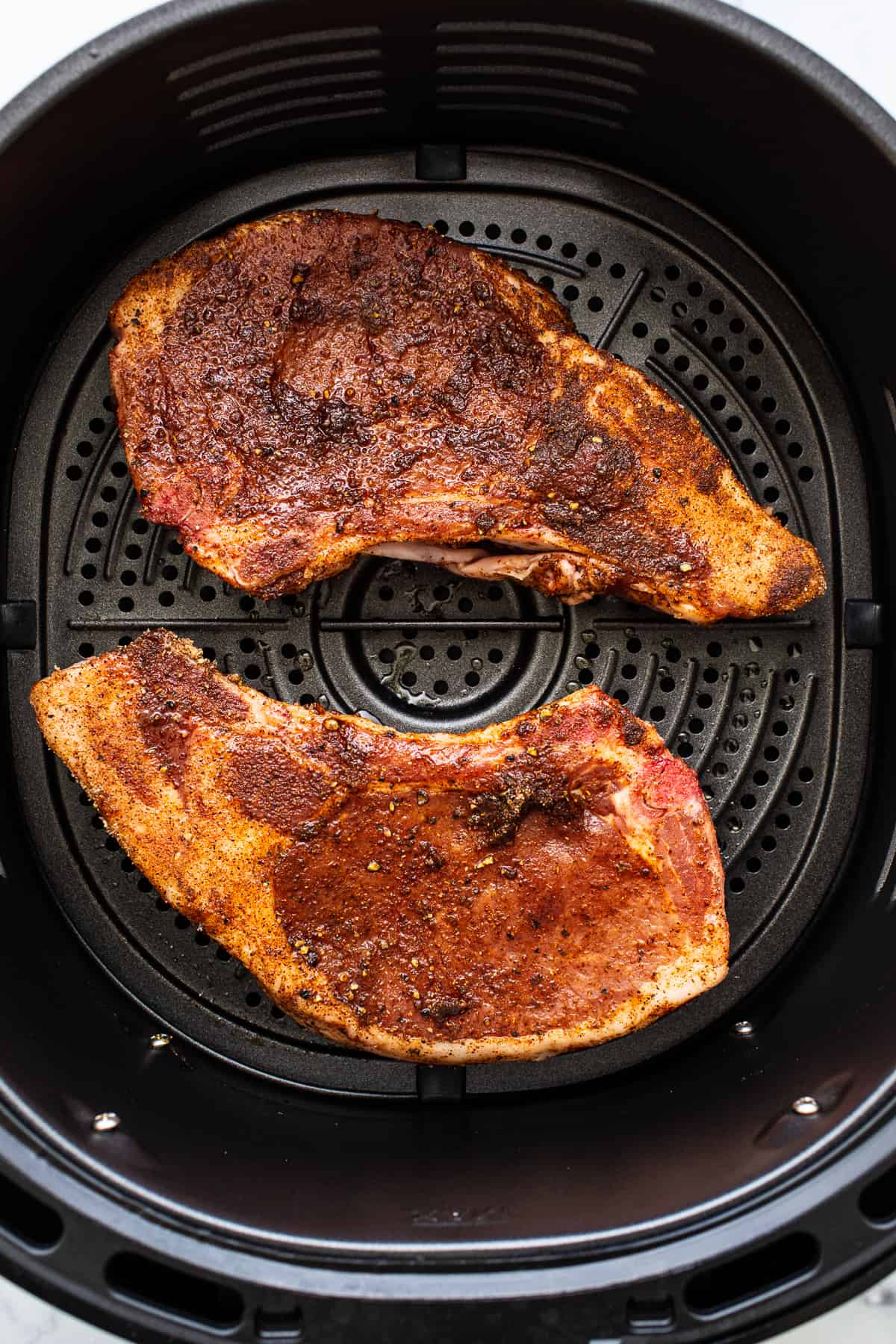 Pork chops in an air fryer.