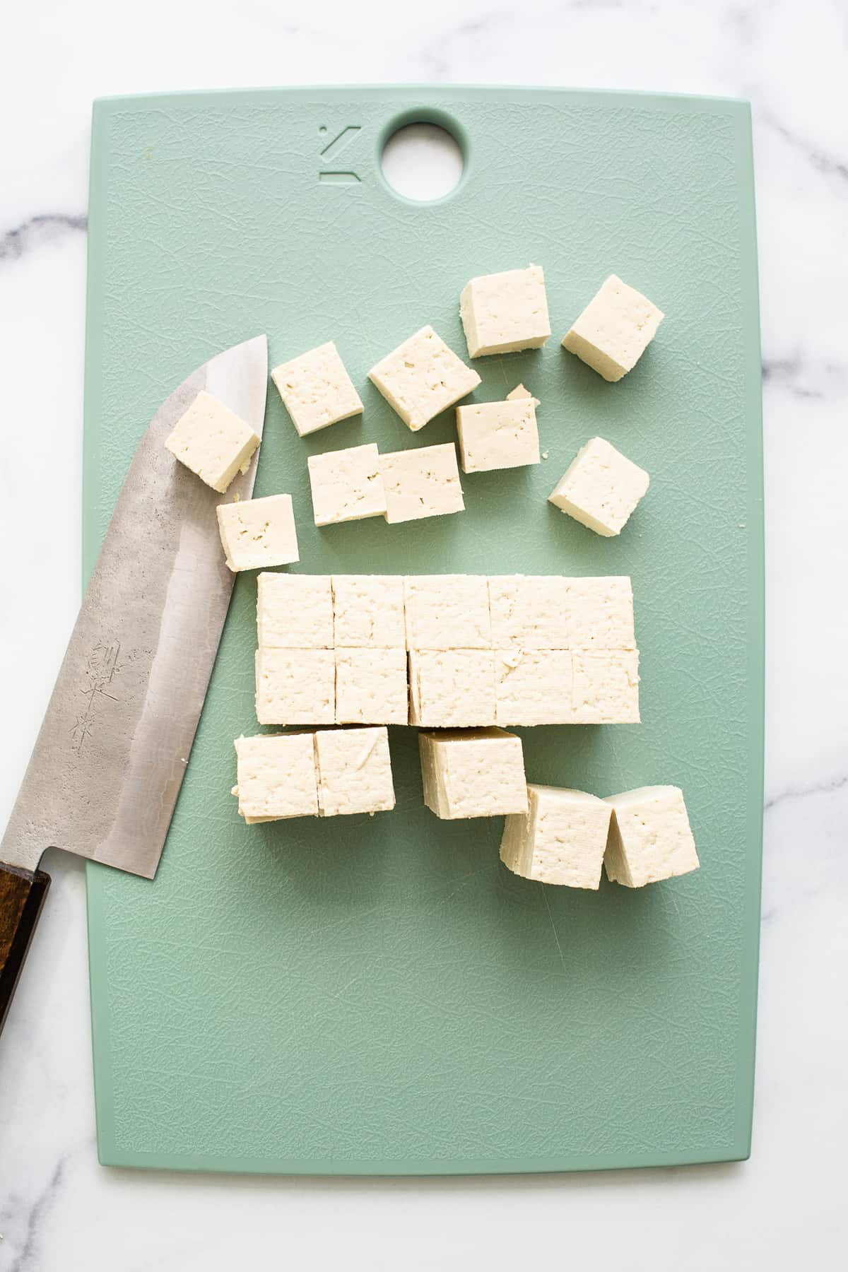 Slicing the tofu into cubes.