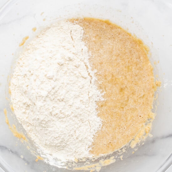 Two bowls of flour and sugar in a glass bowl.