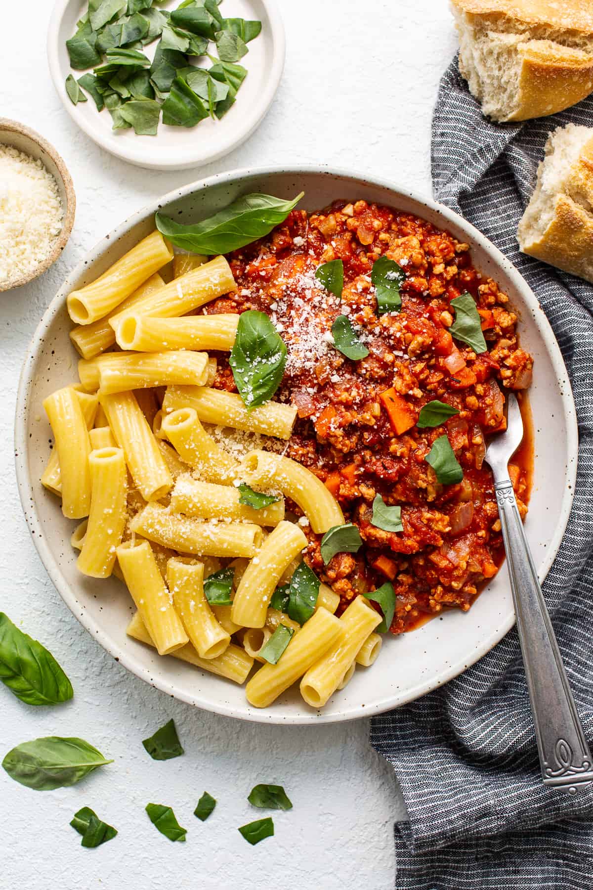 Ground chicken bolognese in a bowl with pasta.