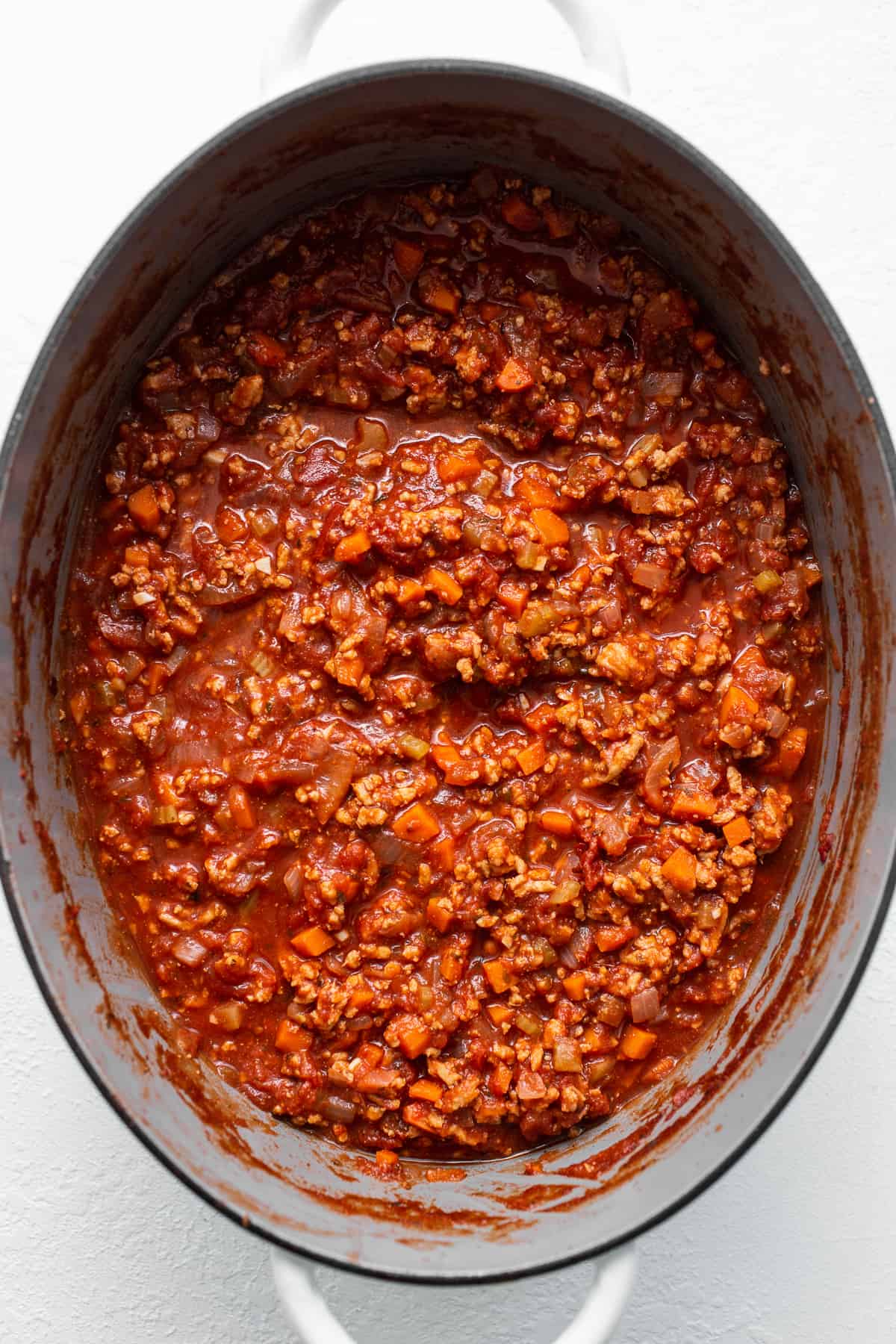 Ground chicken bolognese in a stock pot.