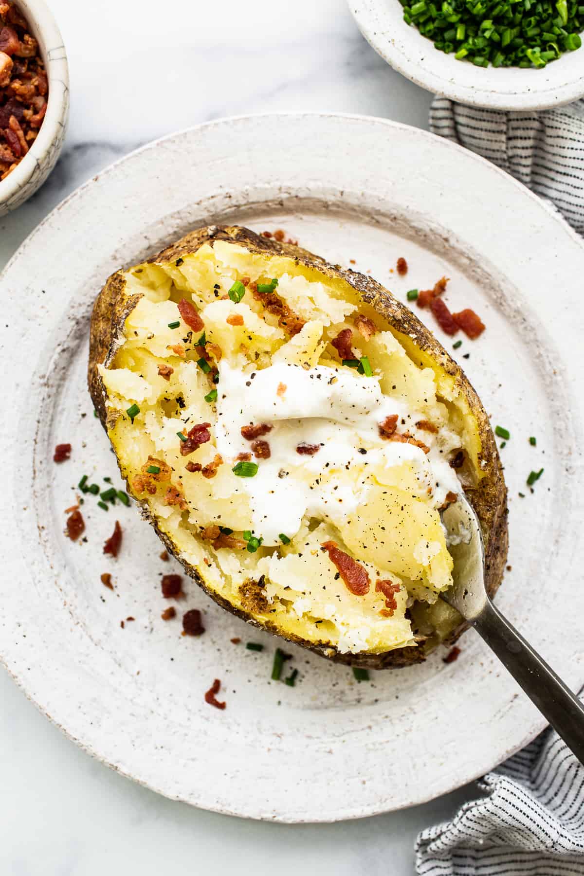 Microwave baked potato with toppings.