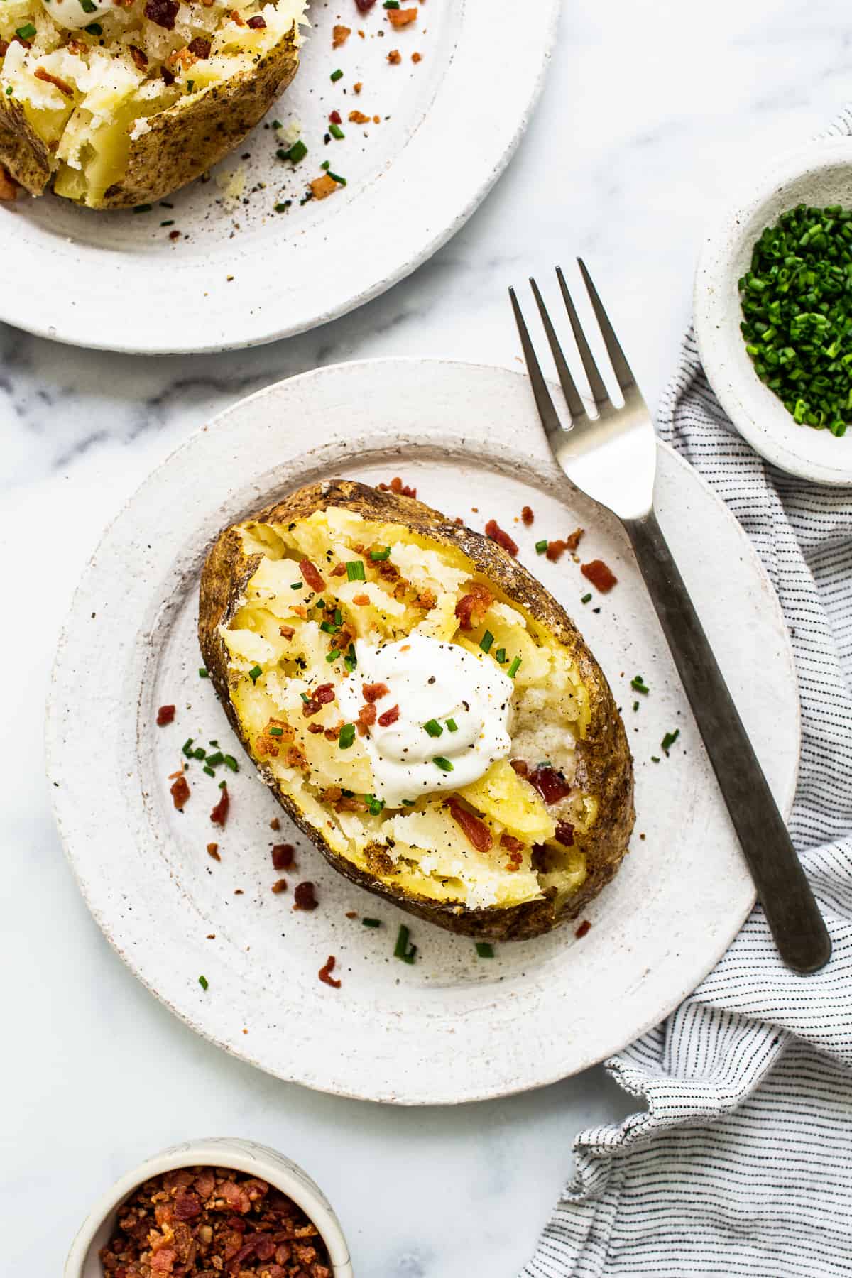 Baked potato topped with sour cream.