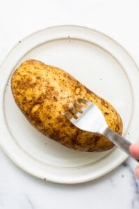 Poking holes in a potato.