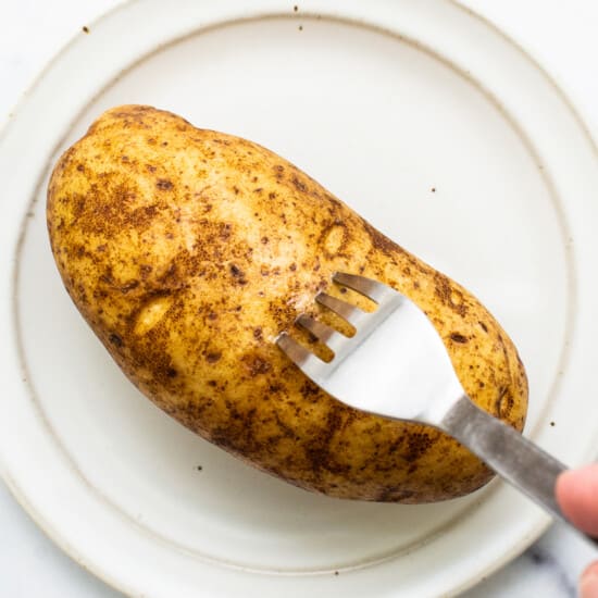 Poking holes in a potato.