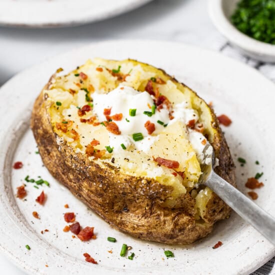 Microwave baked potato with toppings.