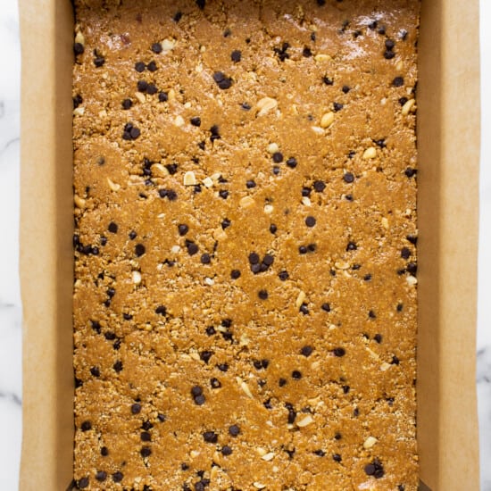 Chocolate chip cookie bars in a baking pan.