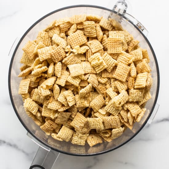 Chex cereal in a bowl on a marble countertop.