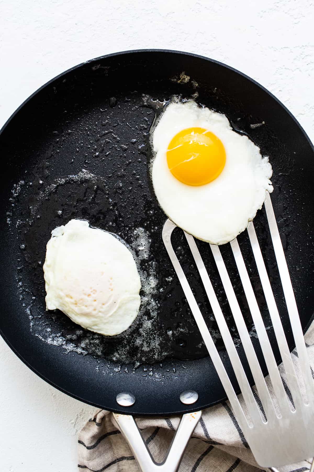 Eggs cooking in a skillet.