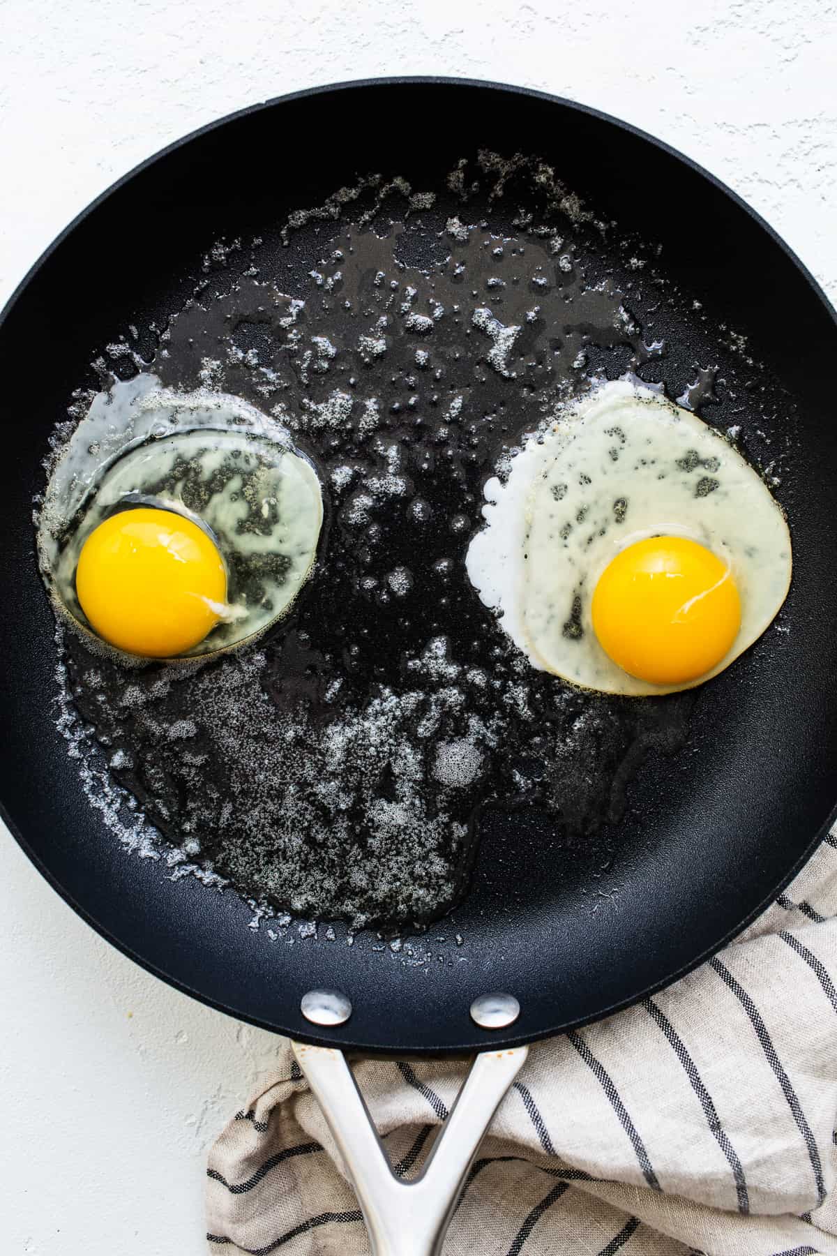 Eggs cooking in a skillet.