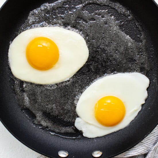 Two fried eggs in a frying pan.