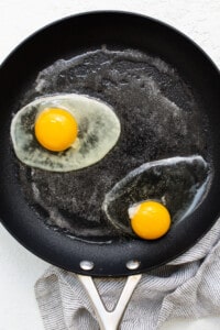 Two fried eggs in a frying pan.