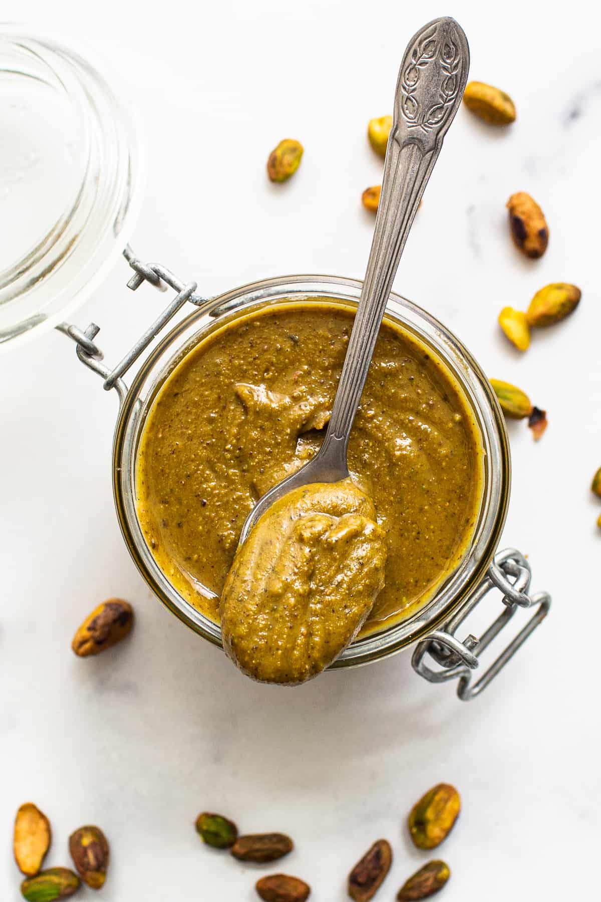 Pistachio butter in a glass container. 