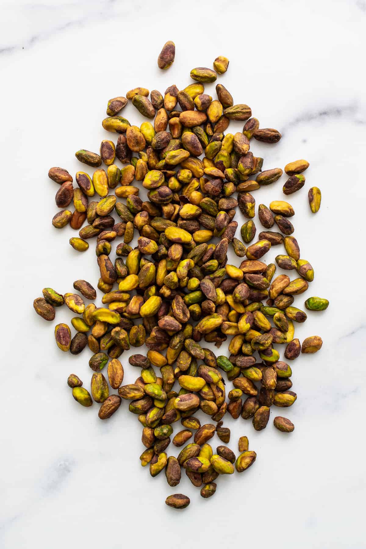 Shelled pistachios on a counter. 