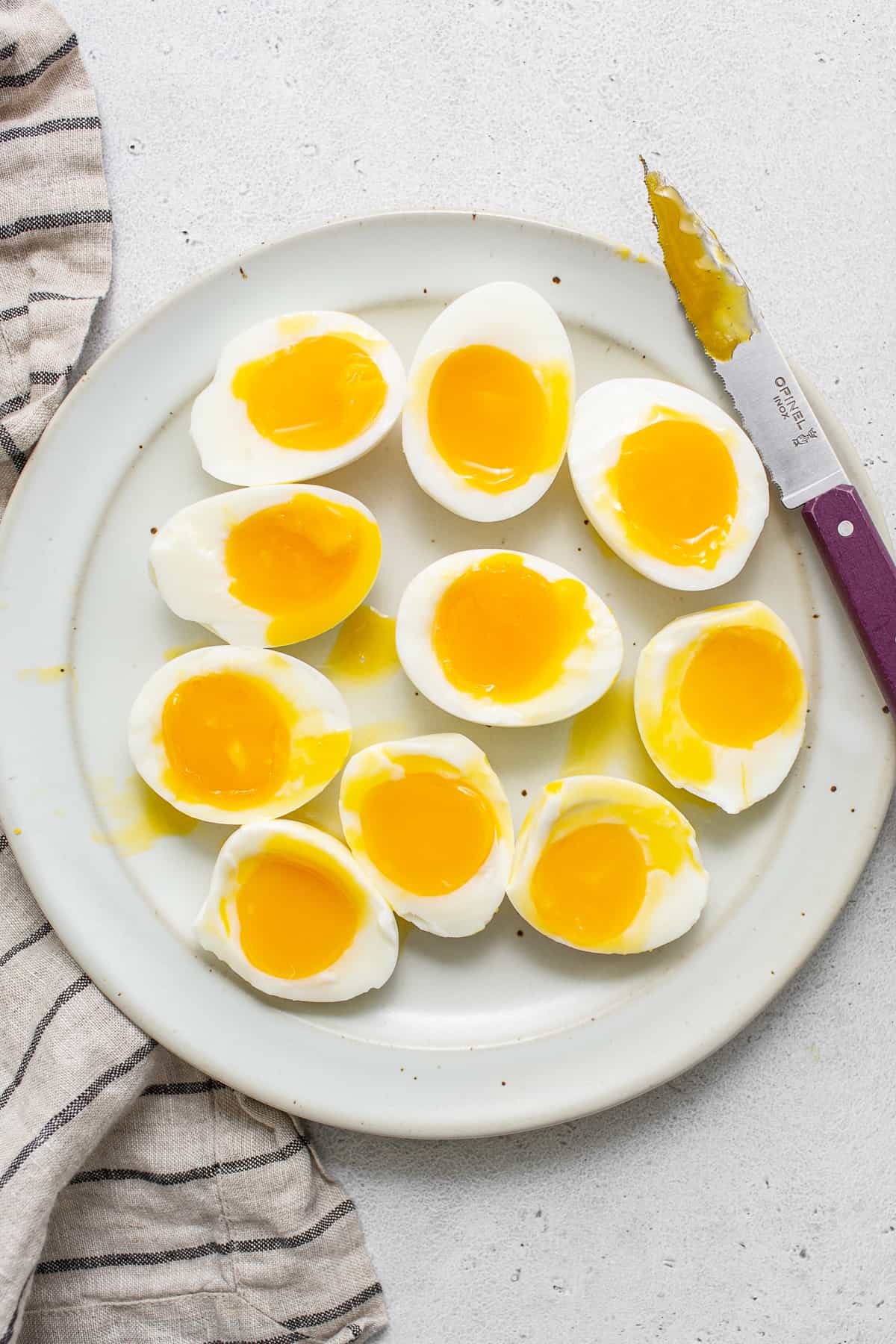 Soft boiled eggs on a plate.