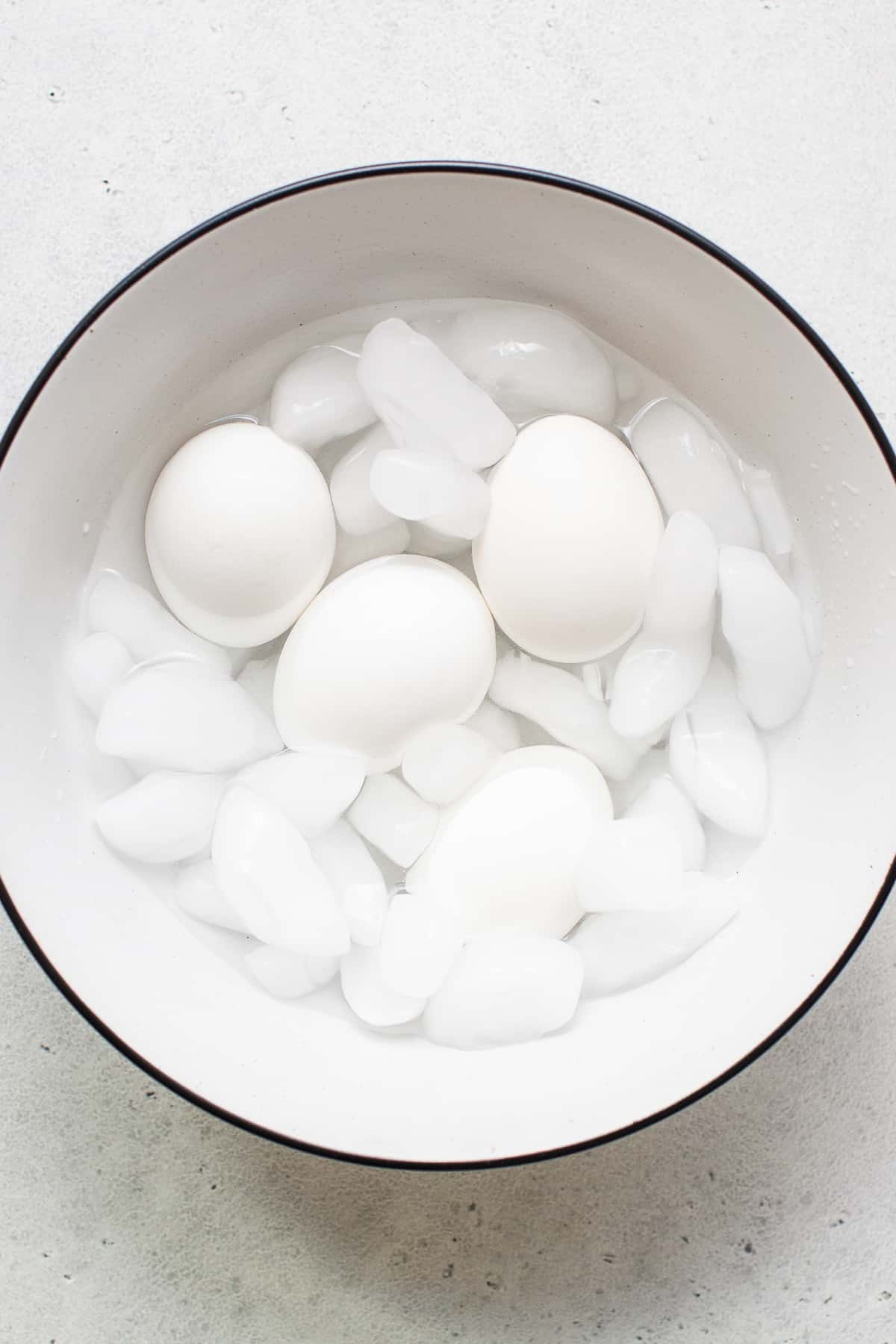 Soft boiled eggs in a bowl with ice.