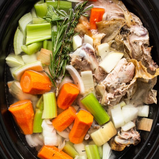 Turkey stock ingredients covered in water.