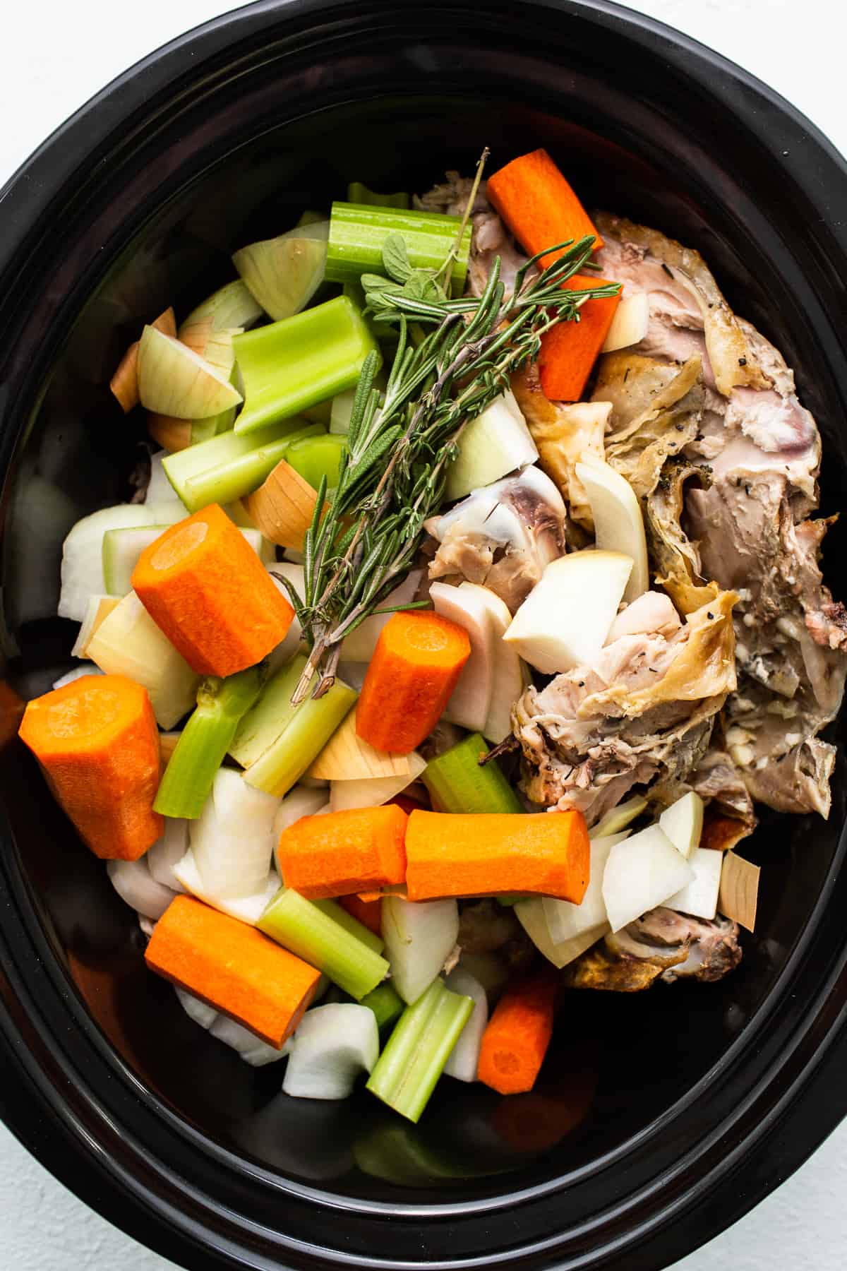 Turkey stock ingredients in a slow cooker. 