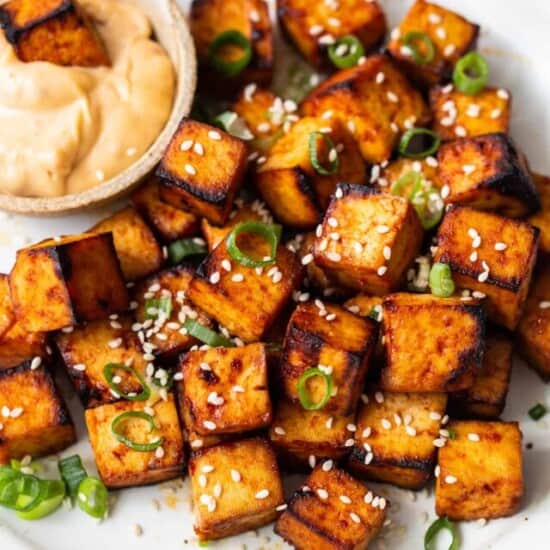 Air fryer tofu on a plate with dipping sauce