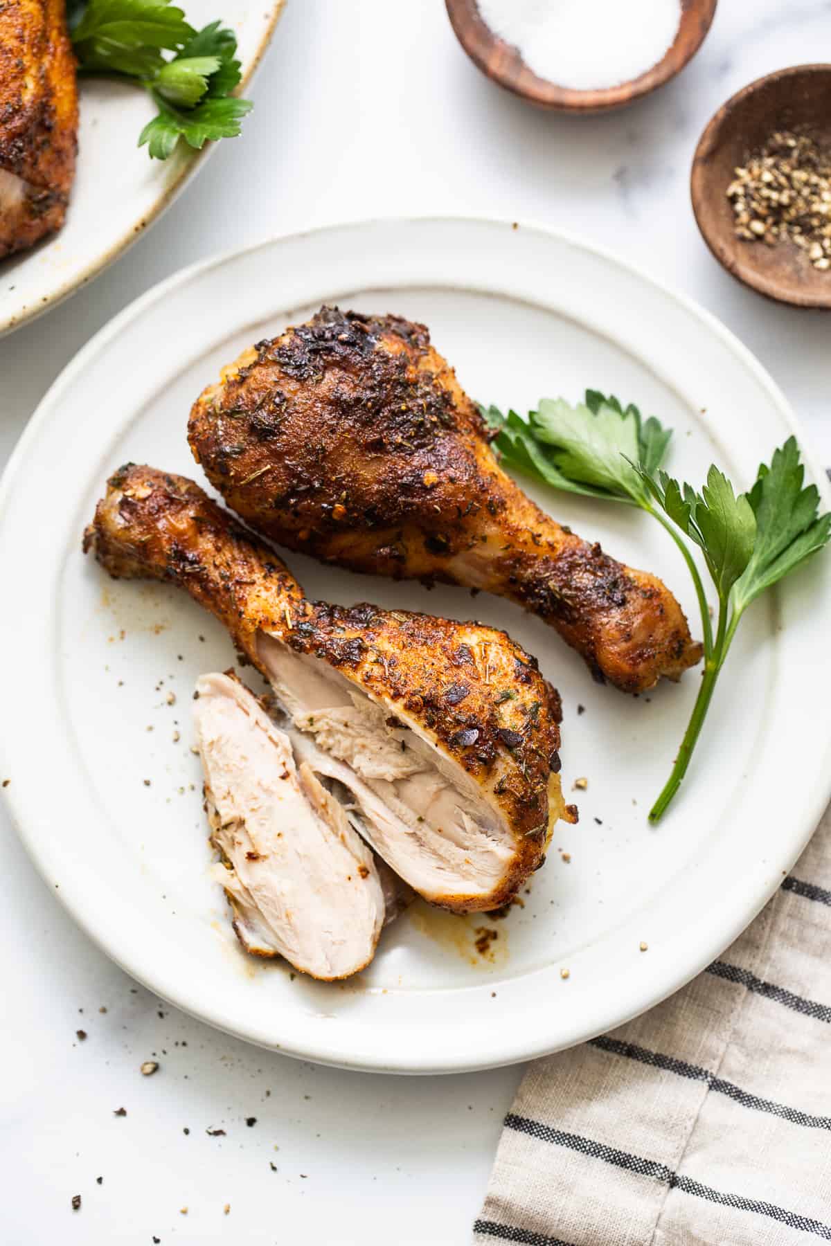 Baked chicken legs on a plate.