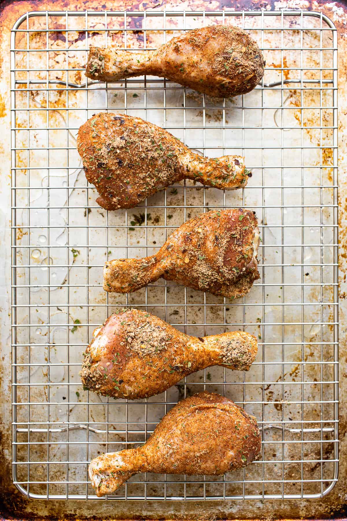 Chicken legs on a wire rack.