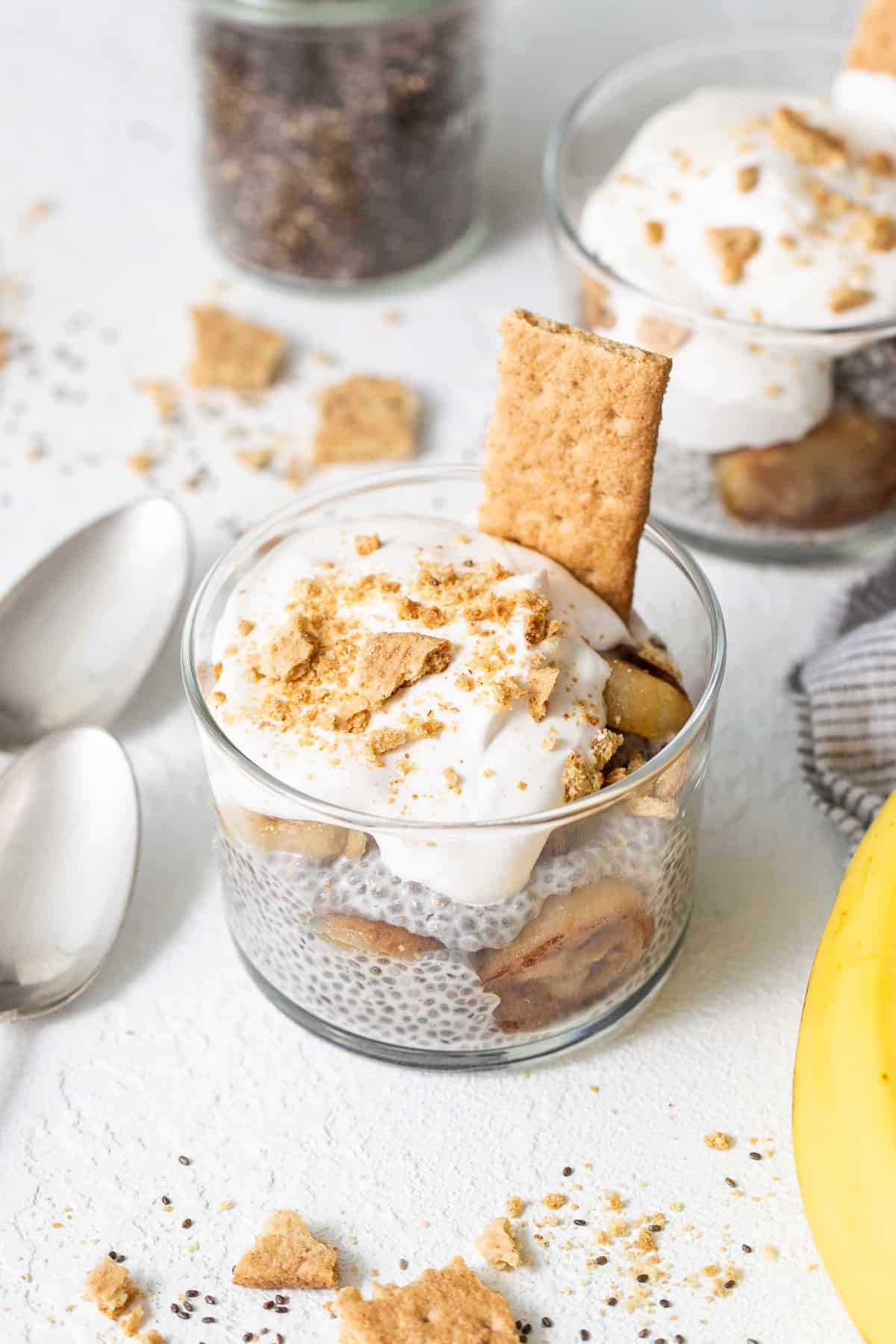 Banana Cream Pie Chia Seed Pudding in a Glass with Whipped Cream and Graham Crackers.