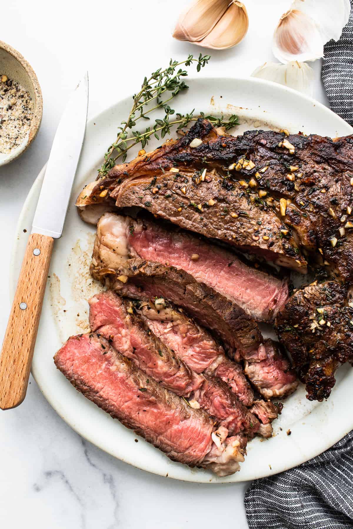 Sliced seasoned steak on a plate.