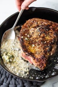 Searing a steak in a cast iron.