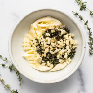 Butter, herbs and garlic in a bowl.