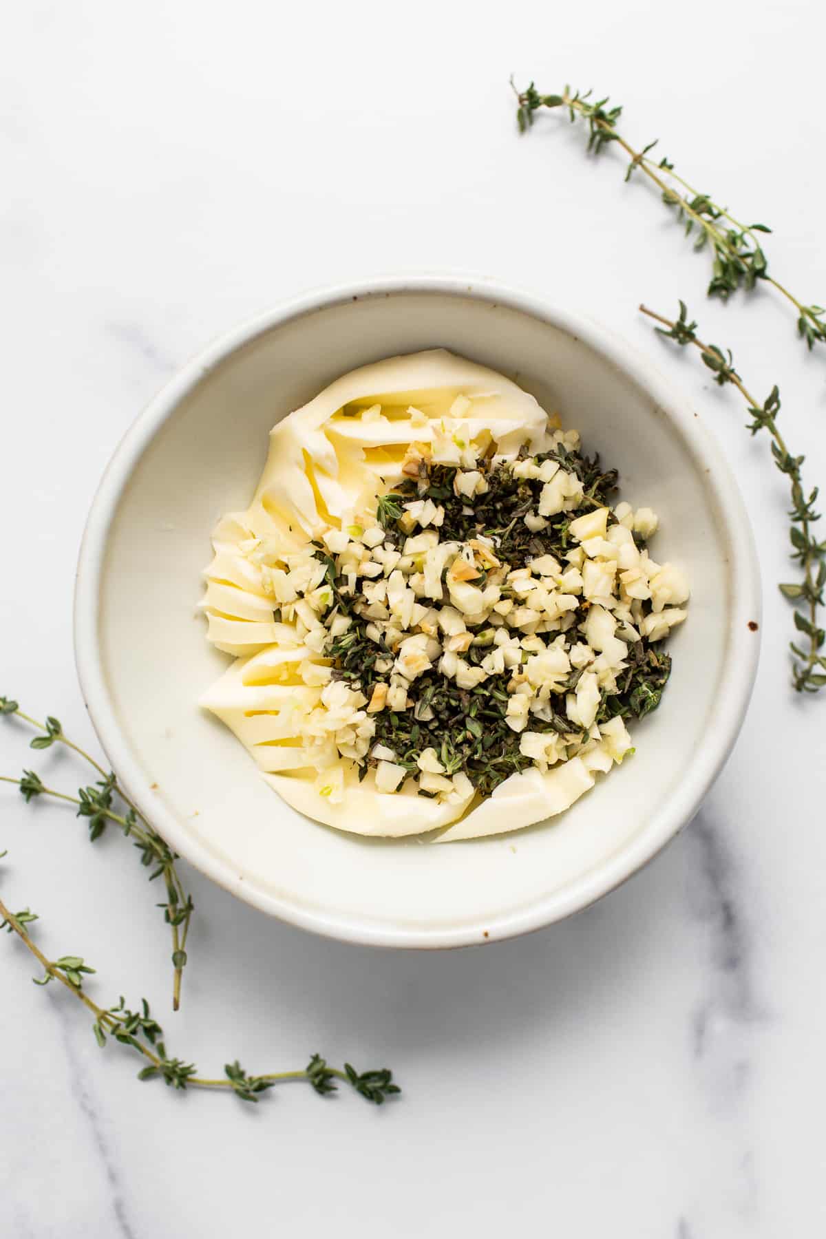 Garlic ،er and herbs in a bowl. 