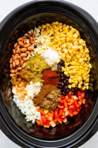 A crock pot full of ingredients for crock pot tacos.