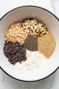 Ingredients in a bowl for nut and coconut bars.