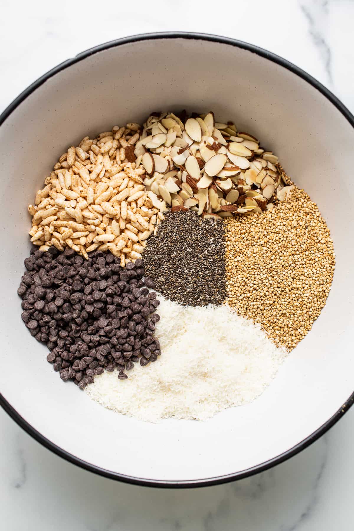 Ingredients for nut and coconut bars in a bowl. 