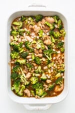 This Orange Chicken Casserole combines a classic takeout meal with easy at-home prep, made with just one dish! uncooked orange chicken casserole in dish.