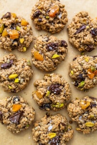 Oatmeal cookies with pistachios and dates on a baking sheet.