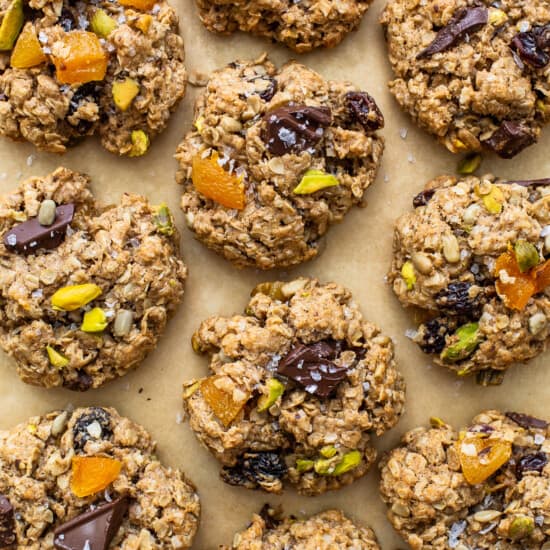Oatmeal cookies with pistachios and dates on a baking sheet.