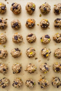 A baking sheet full of granola and pistachio energy bites.
