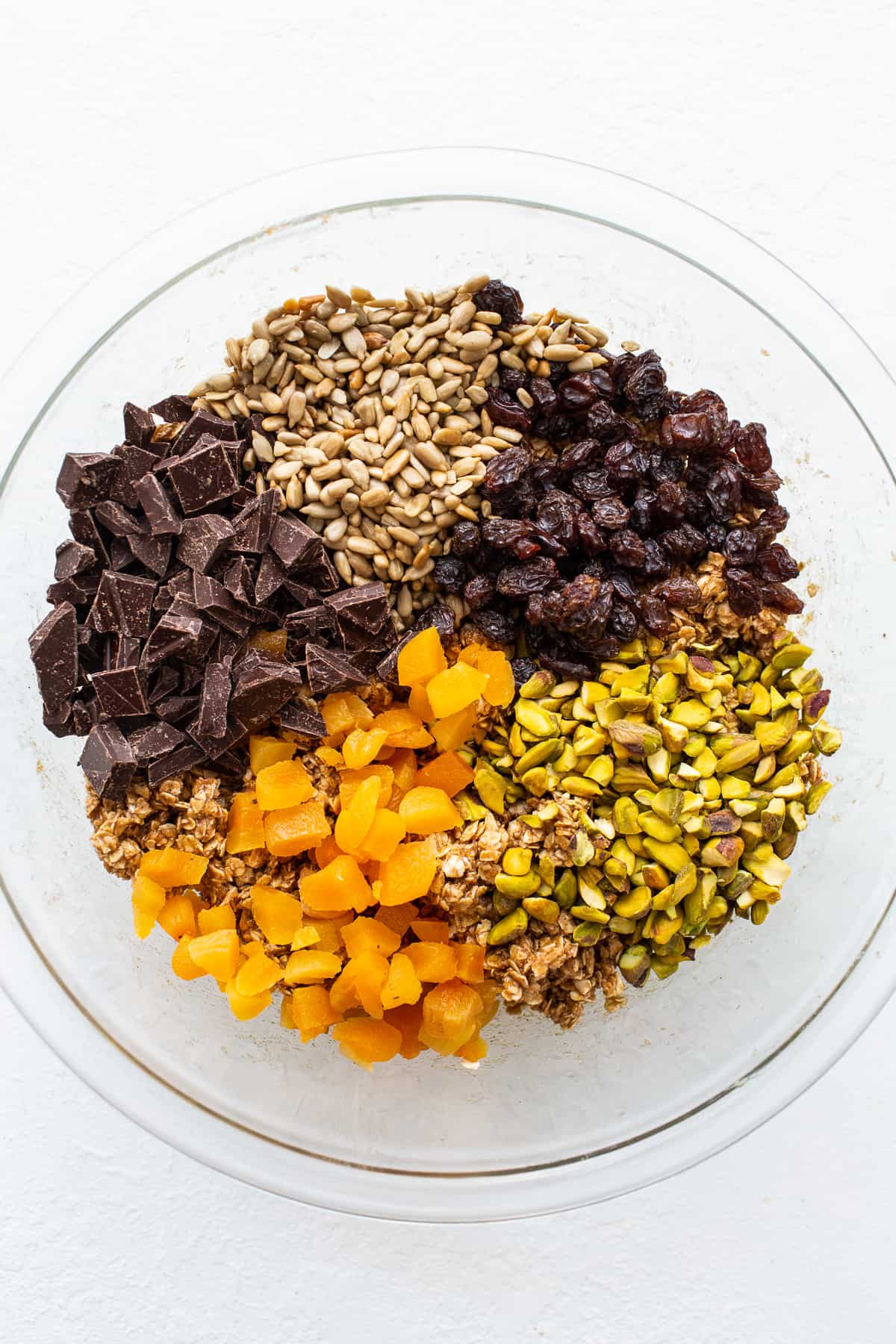 Trail mix cookie ingredients in a bowl.