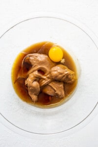 A dish with an egg and sauce on a plate.